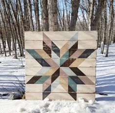 a wooden block with a star design on it in the snow