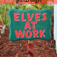 a sign that says elves at work in front of some plants and trees with the words,