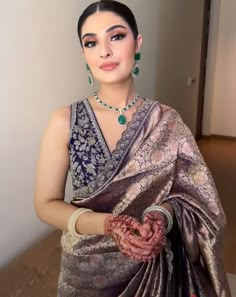 a woman in a sari is posing for the camera