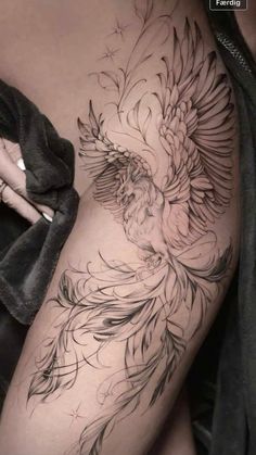 a woman's thigh with a bird tattoo on it