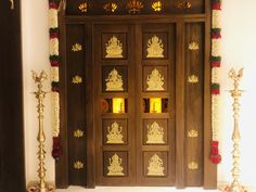 an ornate wooden door decorated with candles and decorations