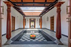 a room with columns and a checkered floor