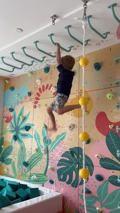 a young boy climbing up the side of a wall