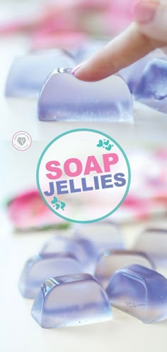 soap jellies are sitting on the table with their hands touching them in front of it