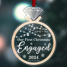 a glass ornament with the words engaged and a diamond hanging from it's center