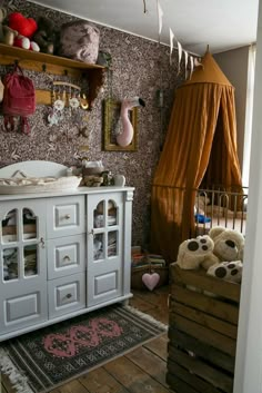 a baby's room with stuffed animals on the floor