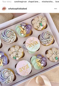 a box filled with lots of cupcakes on top of a table