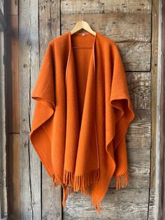 Orange wool blanket open front poncho cape wrap Orange pure lambswool long poncho cape Ladies poncho open front wrap cardigan orange wool One size fits fashionably for most everyone, short or tall, big or small. This piece is versatile for both Men's & Women's outdoor fashion, and can be used insider in cooler winter weather to keep warm while reading on the couch. CARE: Hand-wash and hang to dry, light iron if needed, or dry clean. MEASURES: Length at the front of the neckline to the bottom is Poncho Kimono, Orange Poncho, Womens Outdoor Fashion, Long Poncho, Open Poncho, Open Front Poncho, Blanket Cape, Winter Poncho, Cape Wrap