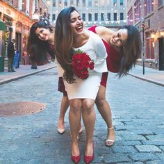 two women are hugging each other on the street with words written in english and chinese