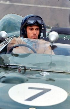 a man sitting in a racing car looking out the window