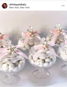 small glass containers filled with white and pink candies