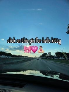 a car driving down a road with the words click on this pin for hello kitty