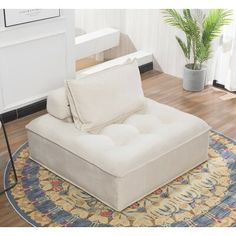 a white couch sitting on top of a rug