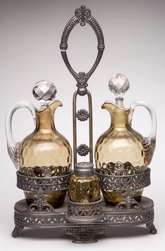 an ornate silver and glass set with two vases