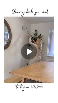 a woman standing in front of a wooden table