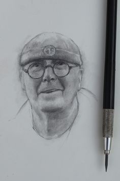 a pencil drawing of an old man wearing glasses and a hat with a pen next to it