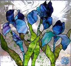 a stained glass window with blue and green flowers