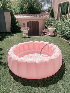 an inflatable pool is sitting on the lawn