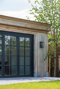 an outside view of a building with glass doors and wood sidings on the side