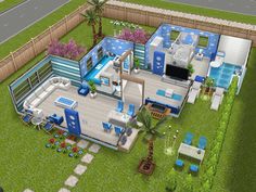 an aerial view of a blue and white house in the middle of a green yard