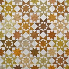 an old quilt with many different colors and shapes on it's sides, including stars