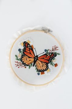 an embroidered butterfly on a white background