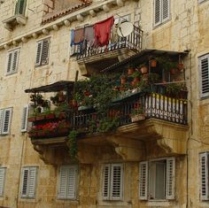 an apartment building with balconies and flower boxes on the balcony, in europe