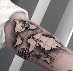 a man's arm with a black and white map tattoo on the left forearm