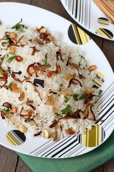 a white plate topped with rice and nuts