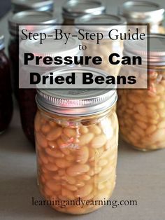 jars filled with beans sitting on top of a table