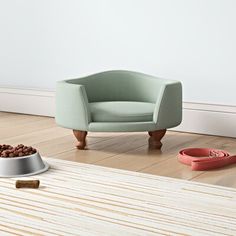 a dog bowl and cat bed on the floor