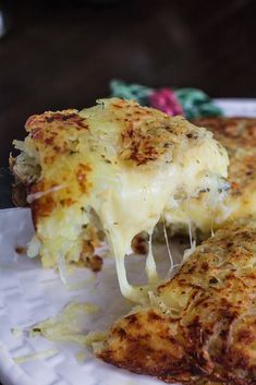 a piece of cheese pizza on a paper plate with a knife and fork in it