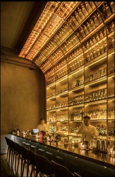 a bar with many bottles on the shelves