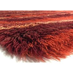 an area rug with red and brown colors