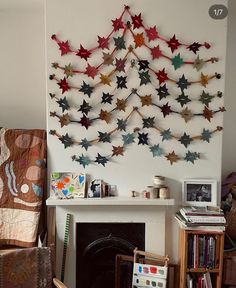 a living room filled with furniture and a fire place next to a wall mounted art piece