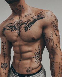 a shirtless man with many tattoos on his chest