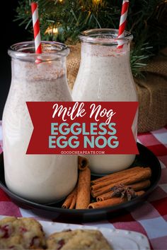 two glasses of egg nog on a plate with cinnamon sticks and cookies in the background