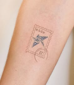 a small tattoo on the arm of a person with a star and moon in it