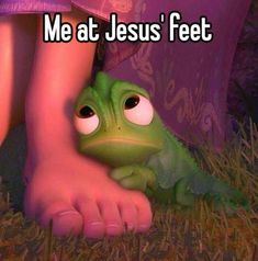 a frog that is laying down next to a person's foot with the caption me at jesus'feet