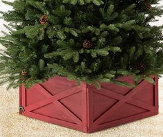 a small christmas tree in a red wooden planter