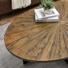 a coffee table with a book on it and a plant sitting on top of it