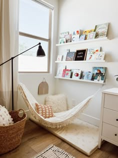 a hammock in a room with books on the shelves