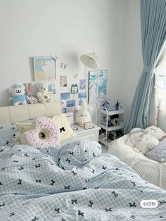 a bed room with two beds covered in blankets and stuffed animals on top of them