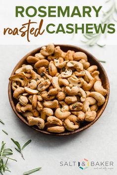 rosemary roasted cashews in a wooden bowl with text overlay that reads rosemary roasted cashews