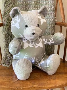 a stuffed animal sitting on top of a wooden chair