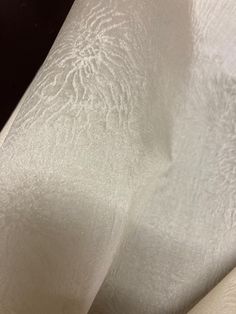 close up view of white fabric with black background