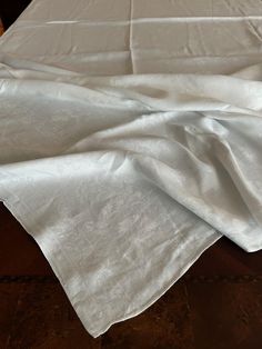 a white table cloth on top of a wooden table