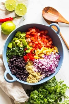 the ingredients for this mexican salad are in a blue bowl