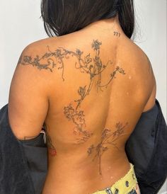 the back of a woman with tattoos on her body