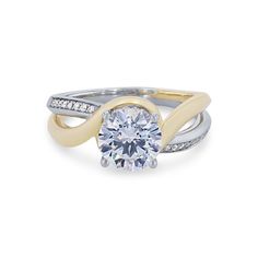 an engagement ring with two tone gold and white diamonds on the band, set in 18k